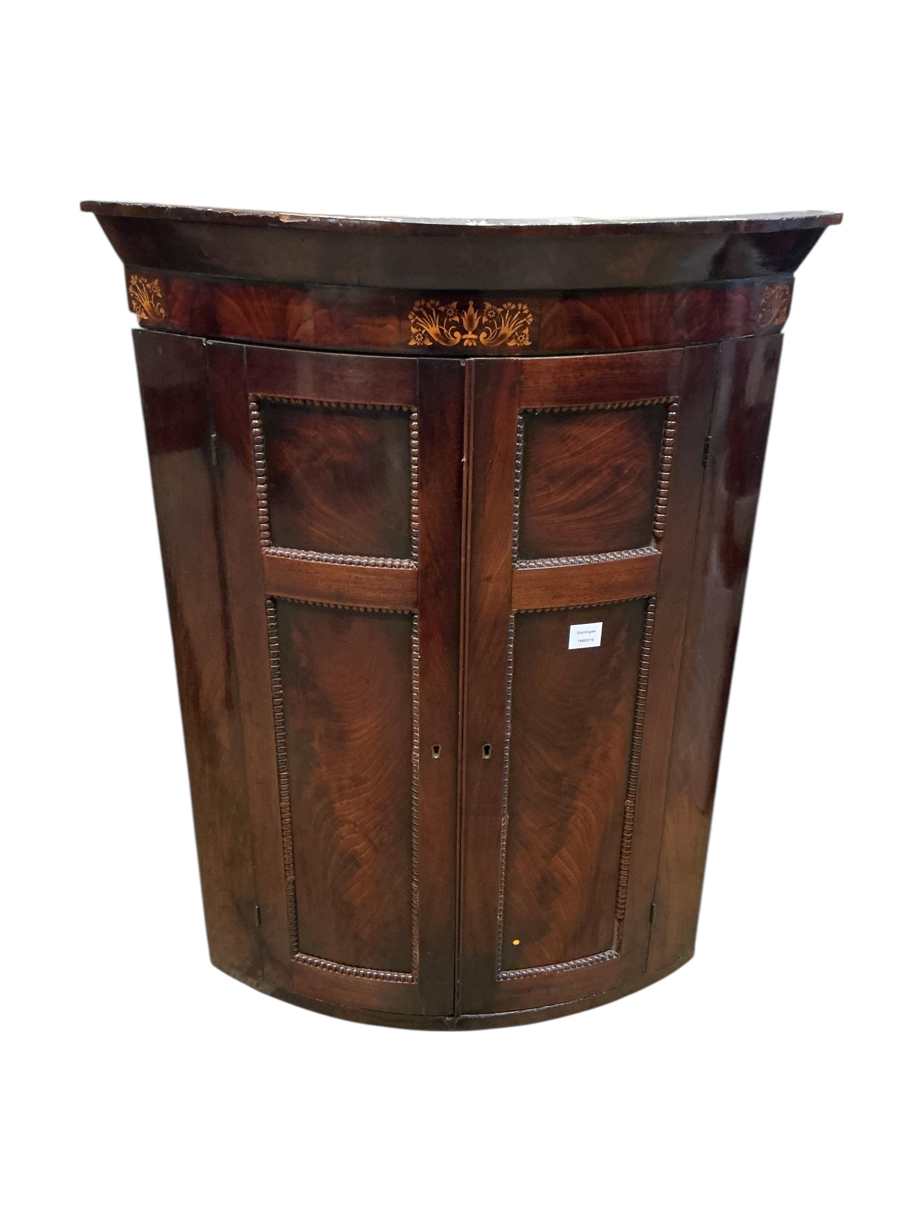 A George IV inlaid mahogany bow fronted hanging corner cupboard, width 80cm, depth 54cm, height 108cm